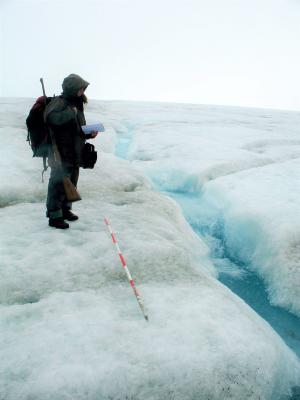Osoba stająca przy potoku supraglacjalnym